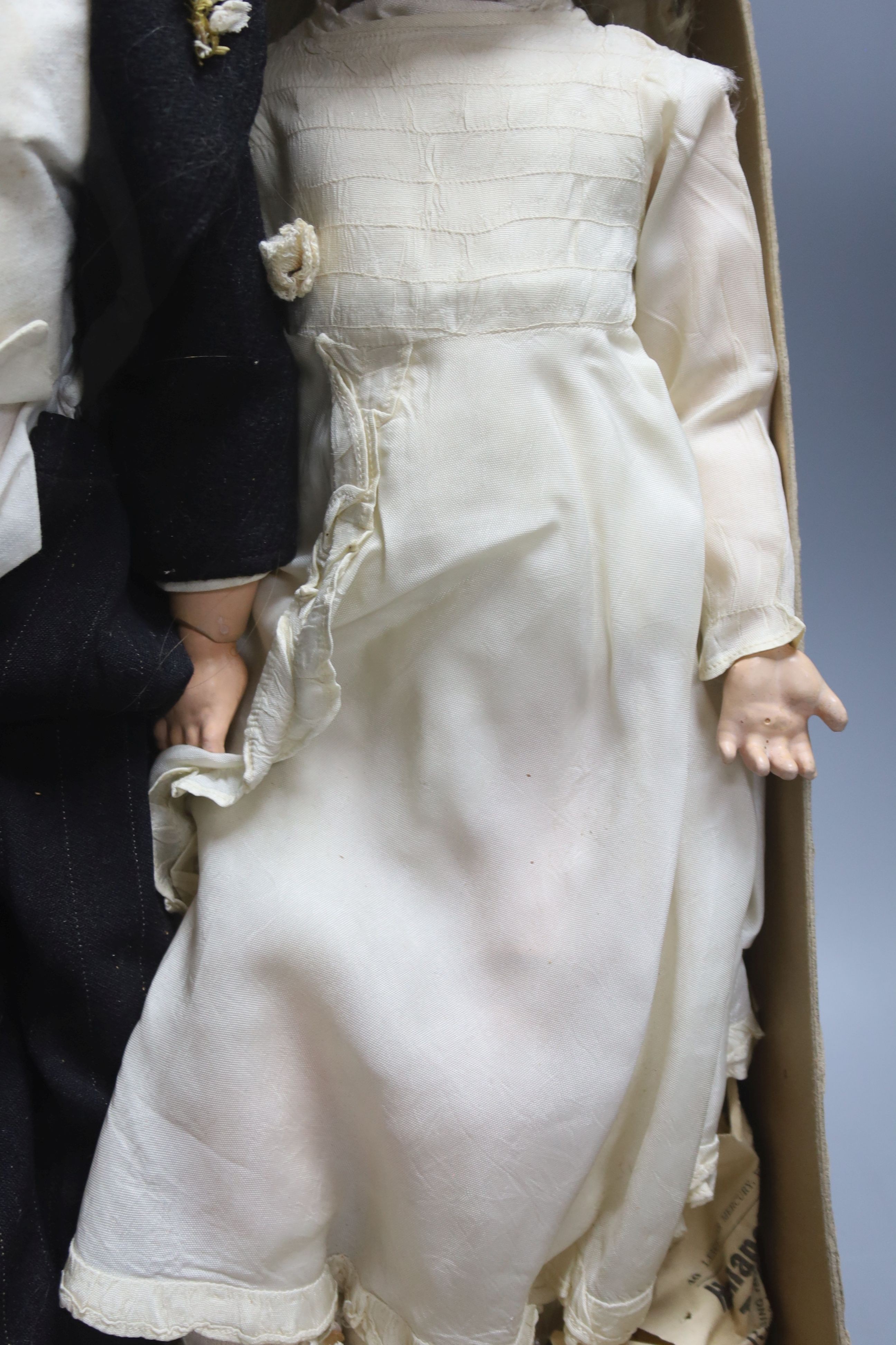 A pair of Armand Marseille 390 bisque head groom and bride dolls, tallest 50cm